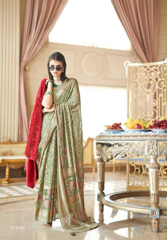 Woman in a saree with a red shawl in an elegant room.