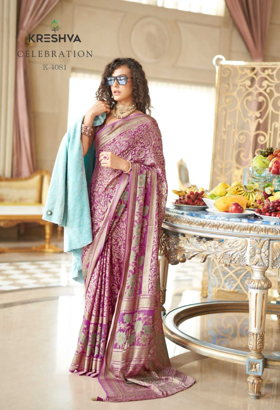 Woman in a pink saree with a decorative setting in the background
