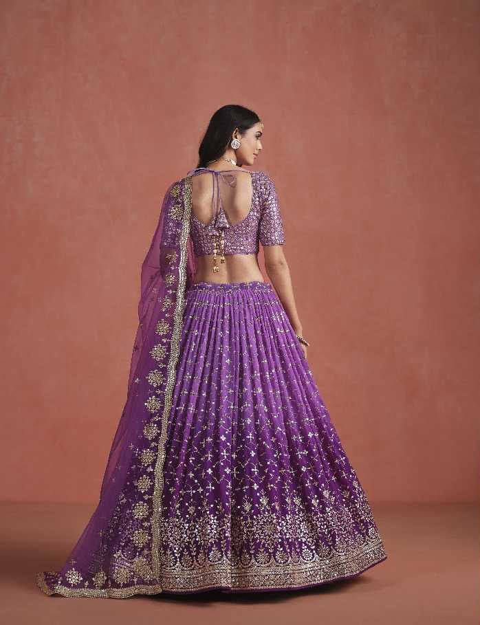 Purple embroidered traditional outfit on a model against a brown background