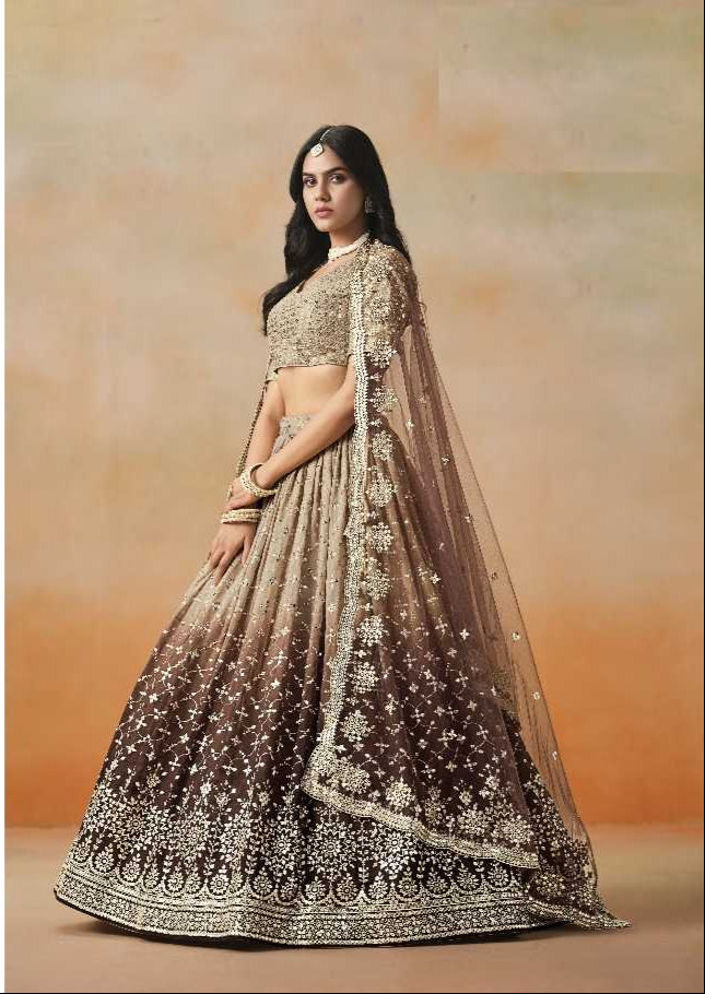 Woman wearing a traditional outfit with a sheer dupatta against an orange background