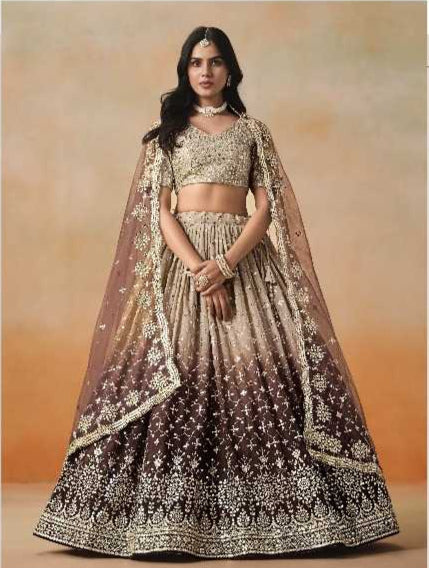 Woman wearing a traditional embroidered outfit with a plain background