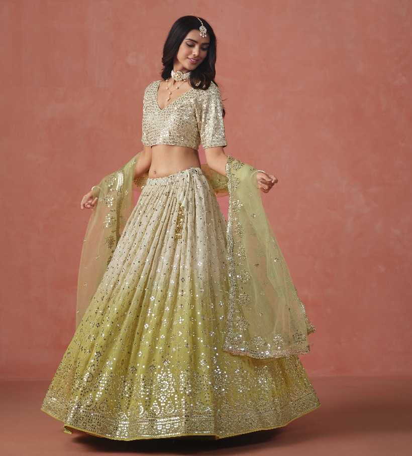 Woman wearing a traditional outfit with gold and green colors on a pink background