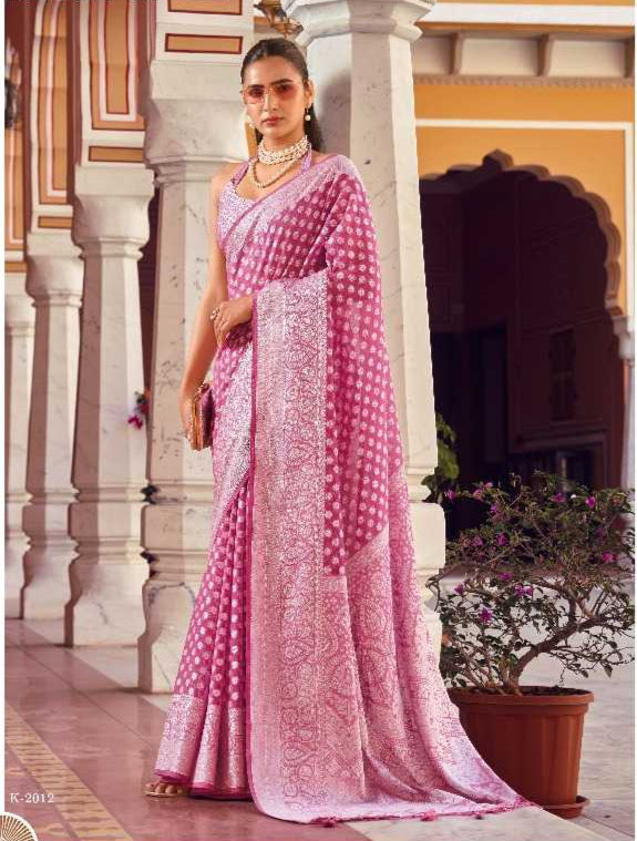 Woman wearing a pink saree with a white background, featuring the brand 'Kreshva'.