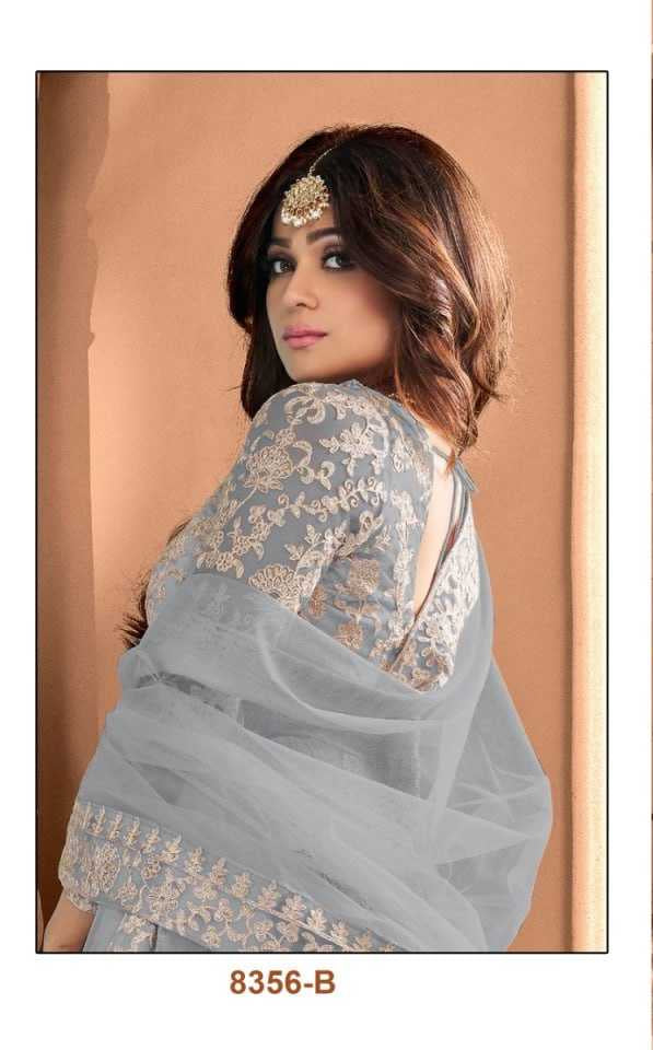 Woman wearing a light blue embroidered dress with a matching dupatta in an indoor setting.