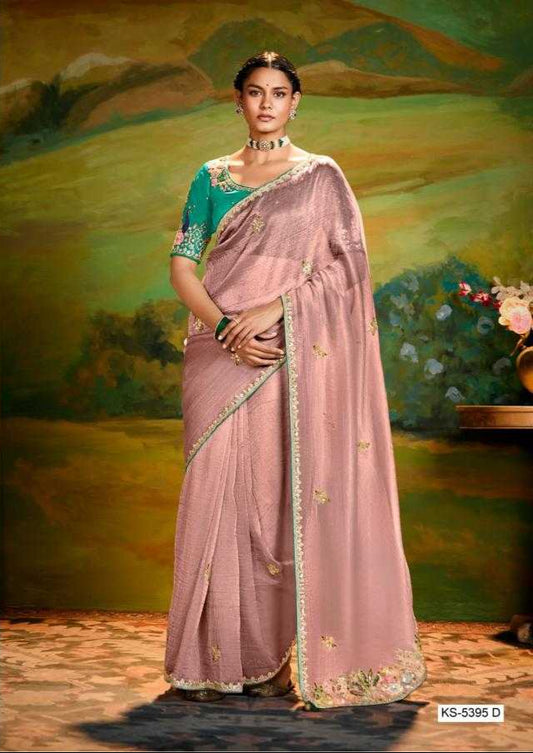 Woman in a traditional saree with a scenic background, featuring the brand 'Kimora'.