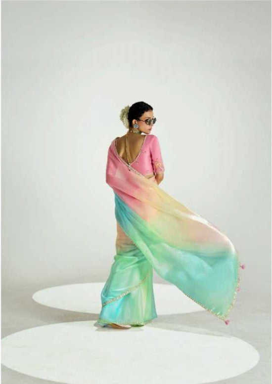Woman wearing a colorful saree with a visible brand name on a white background