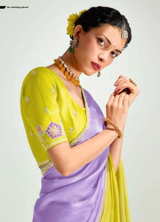 Woman wearing a yellow and purple saree with a white background