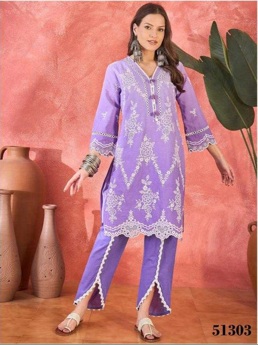 Woman wearing a purple embroidered outfit with a pink background