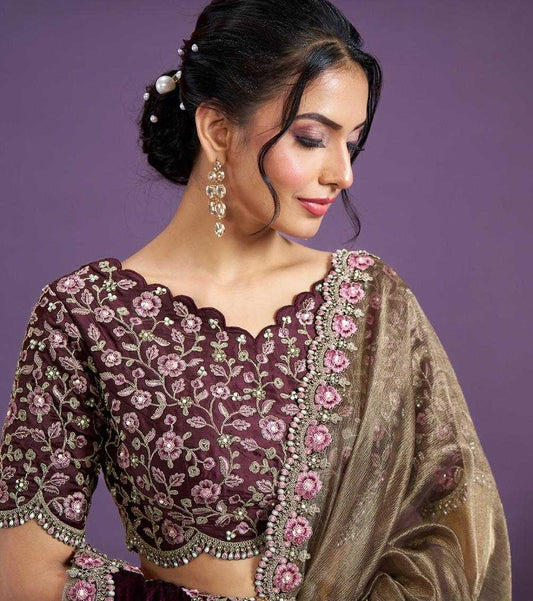 Woman wearing a traditional outfit with intricate designs on a purple background