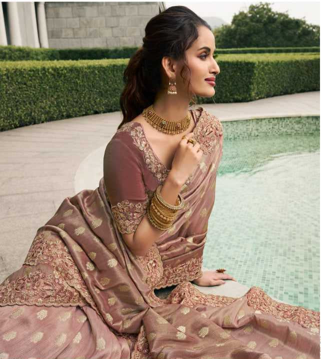 Woman wearing a saree with a pool and building in the background