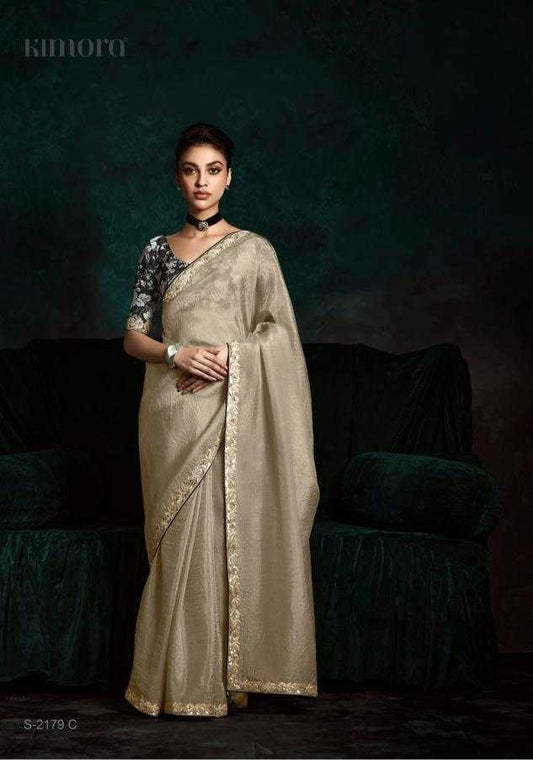 Woman wearing a saree with a dark background
