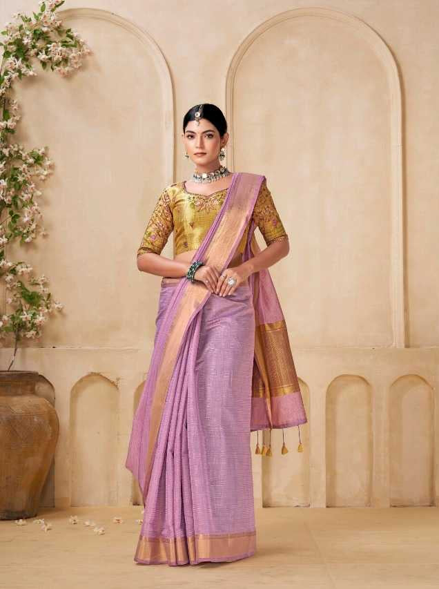 Woman wearing a traditional outfit with a gold blouse and pink saree in an elegant setting.